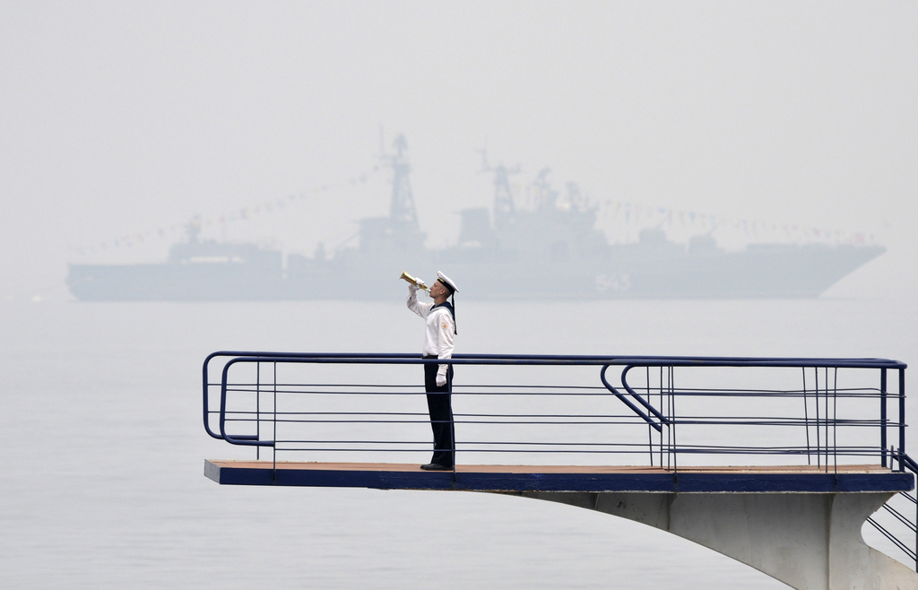 Een Russische matroos neemt deel aan een vlootschouw in de haven van Vladivostok. – © Yuri Maltsev / Reuters 